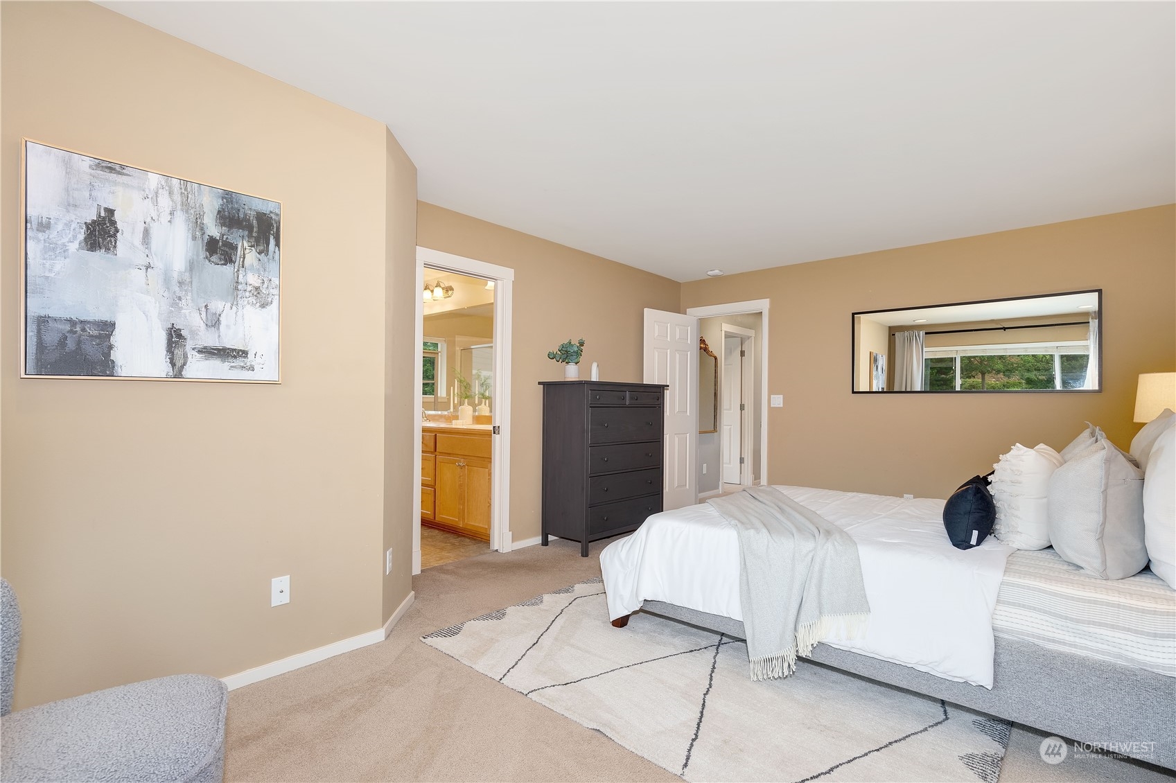 16722 166th Place Southeast Renton, WA 98058 - Photo 18 of 35 a bedroom with a bed and a refrigerator