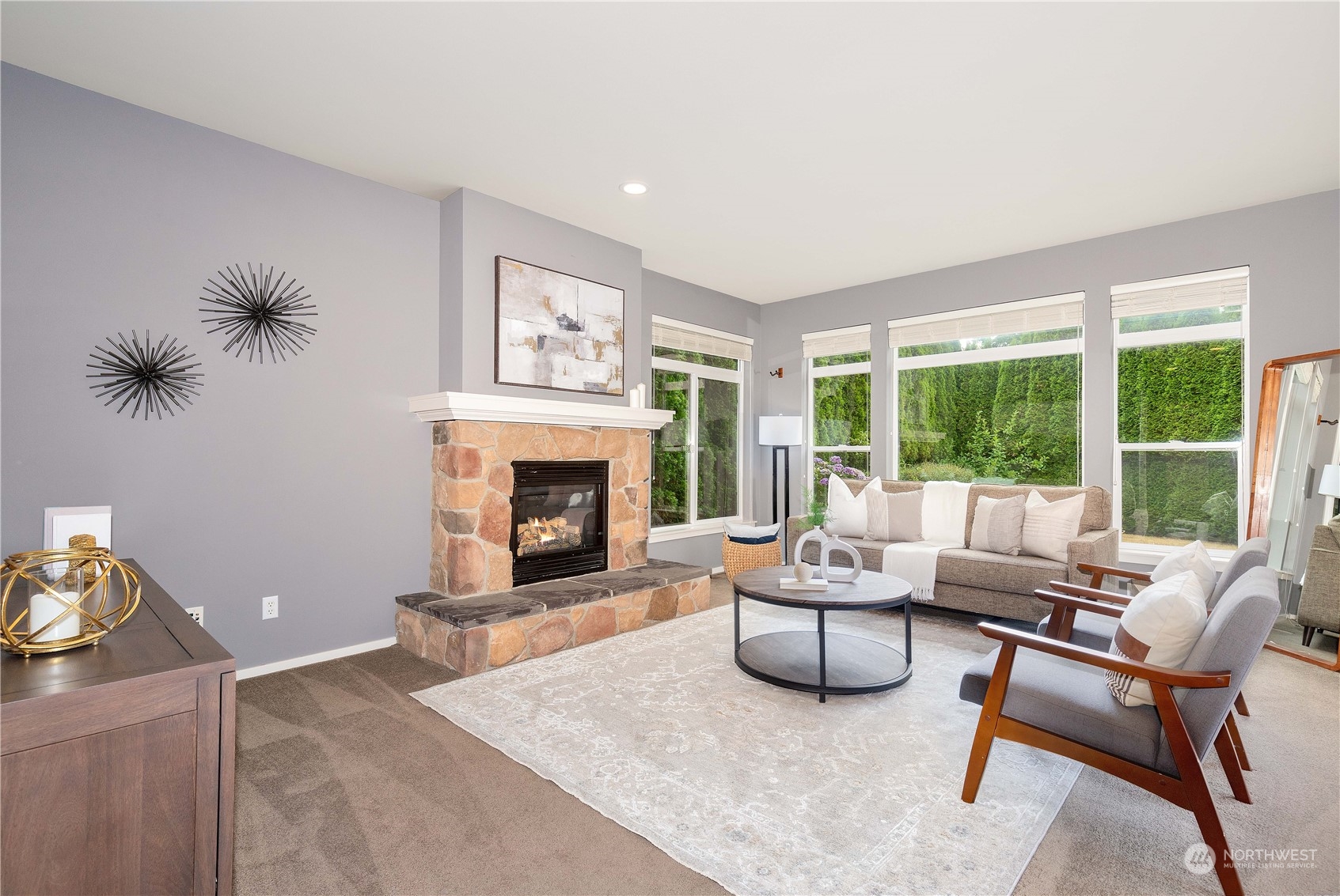 16722 166th Place Southeast Renton, WA 98058 - Photo 5 of 35 a living room with furniture a rug and a fireplace