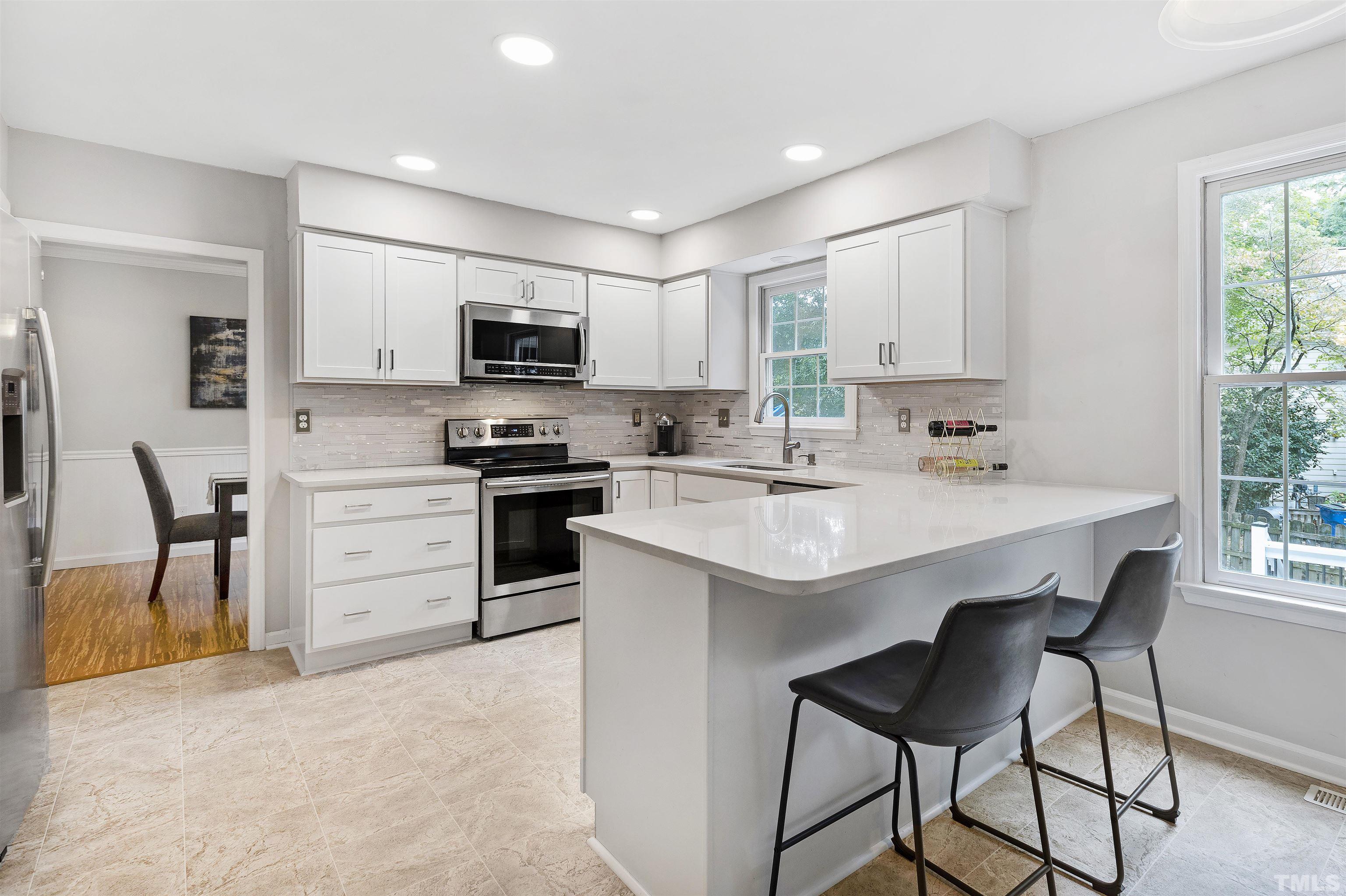 2309 Declaration Drive Raleigh, NC 27615 - Photo 13 of 30 a kitchen with a sink a microwave and refrigerator