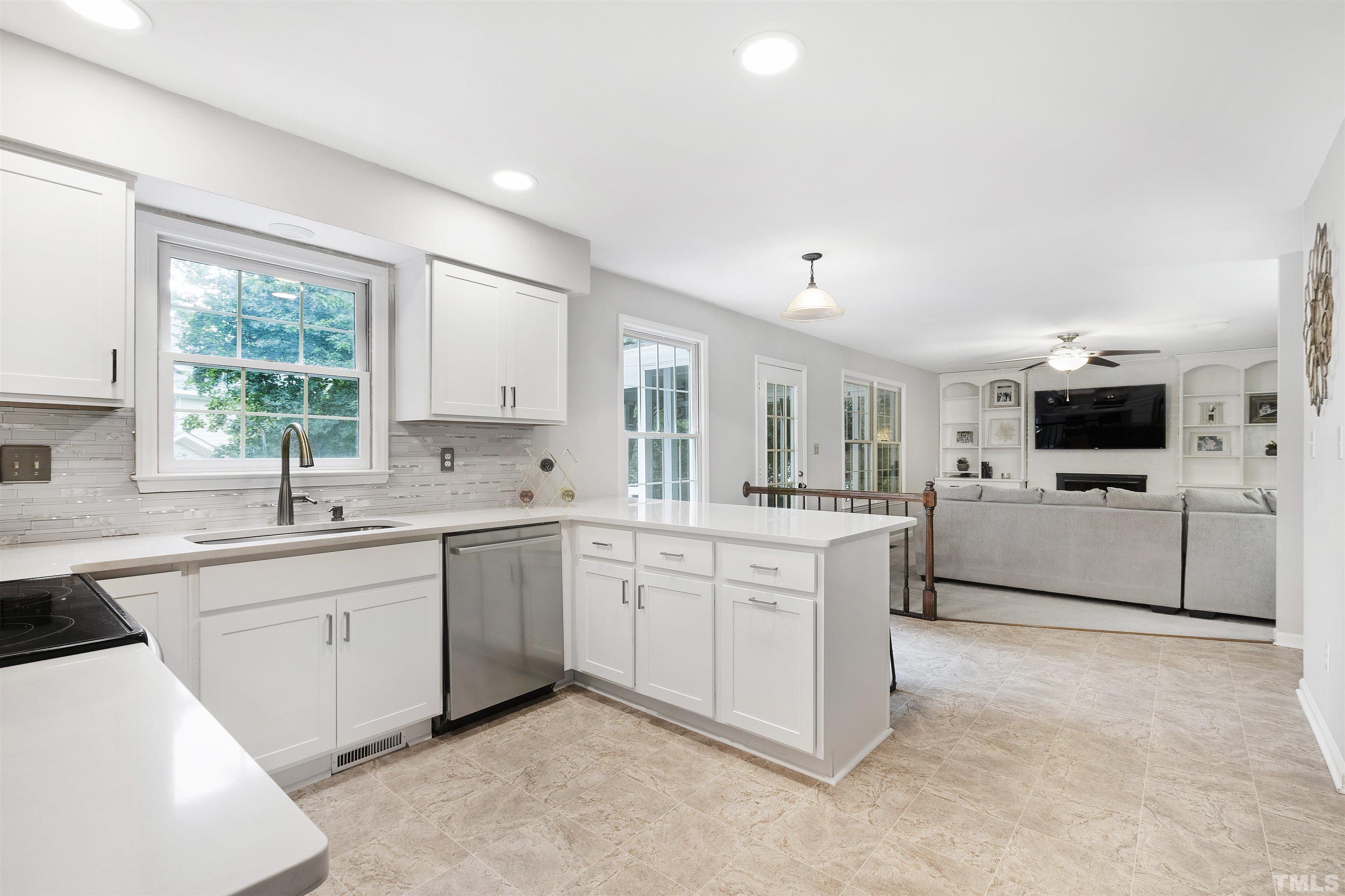 2309 Declaration Drive Raleigh, NC 27615 - Photo 15 of 30 a kitchen with cabinets stainless steel appliances and window