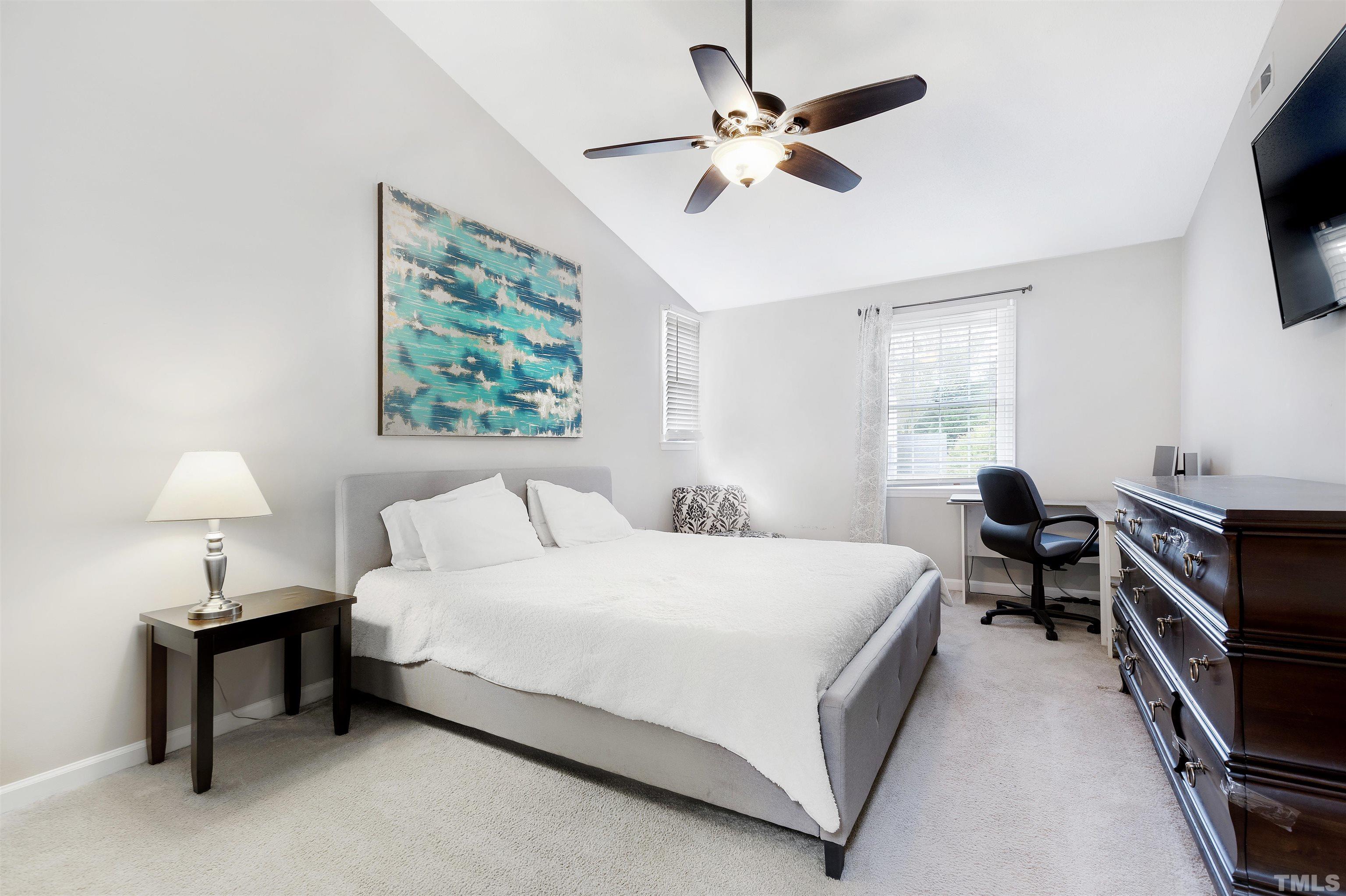2309 Declaration Drive Raleigh, NC 27615 - Photo 17 of 30 a bedroom with a bed and a chandelier