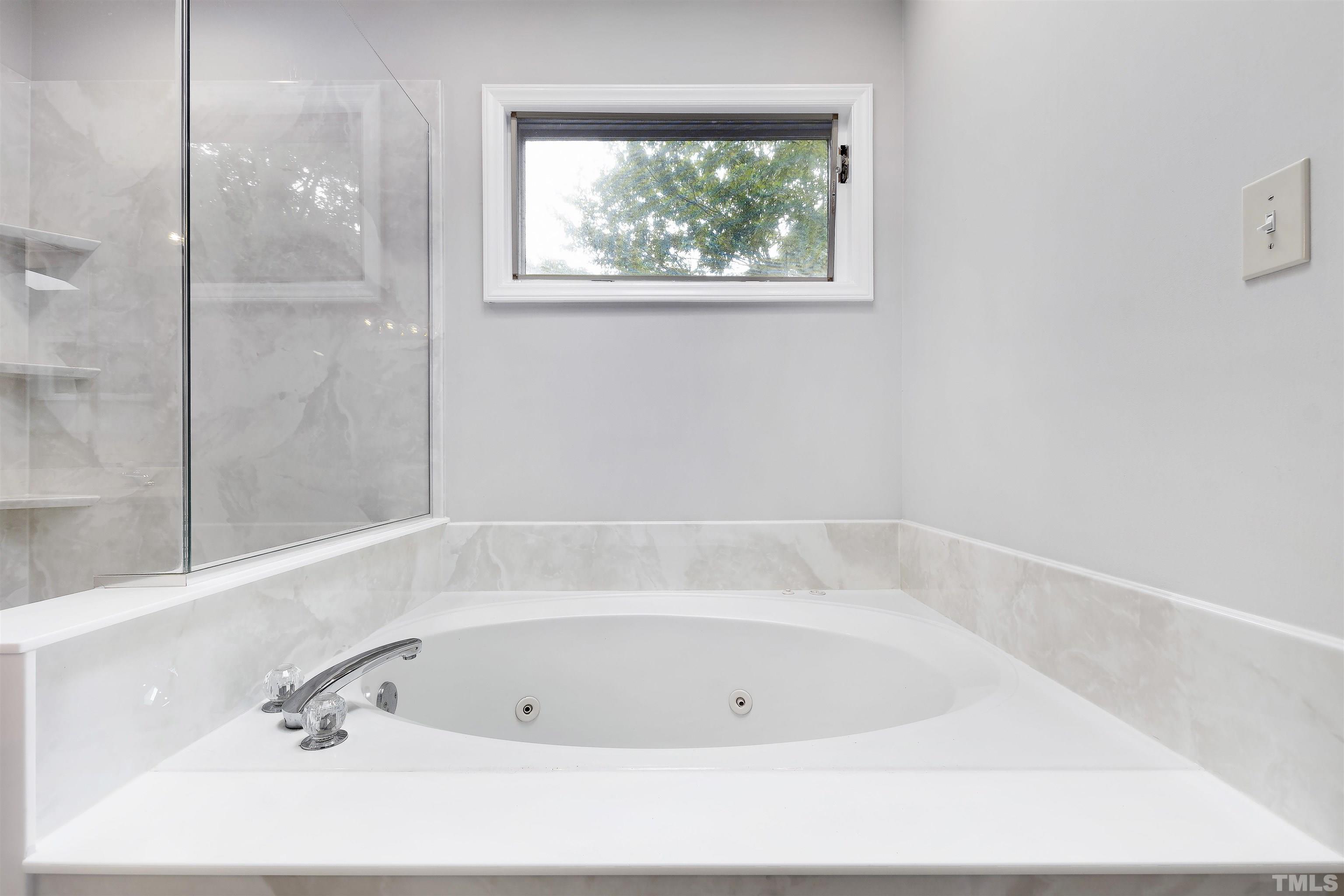 2309 Declaration Drive Raleigh, NC 27615 - Photo 19 of 30 a bathroom with a bathtub and window