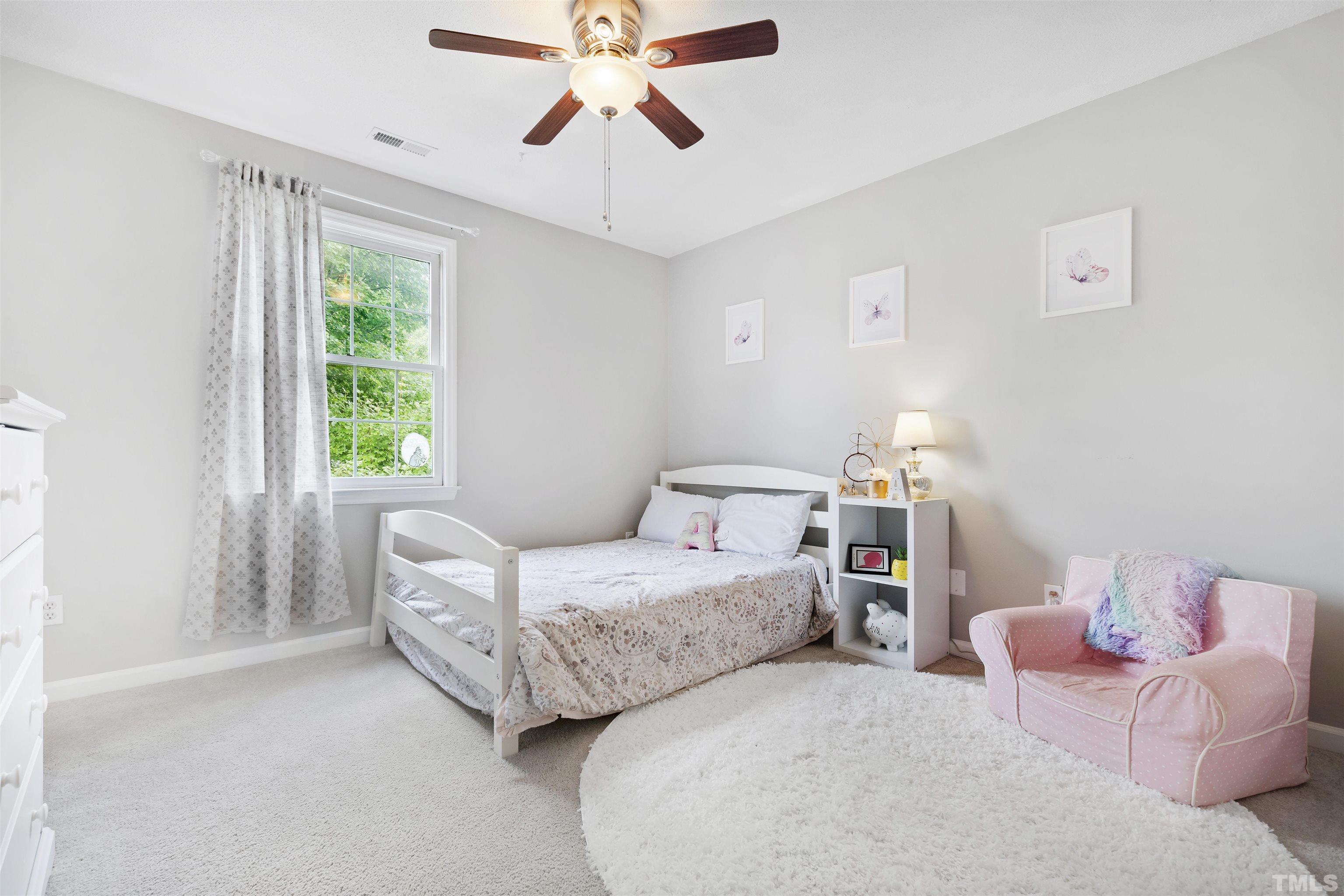 2309 Declaration Drive Raleigh, NC 27615 - Photo 20 of 30 a bedroom with a bed and a chandelier