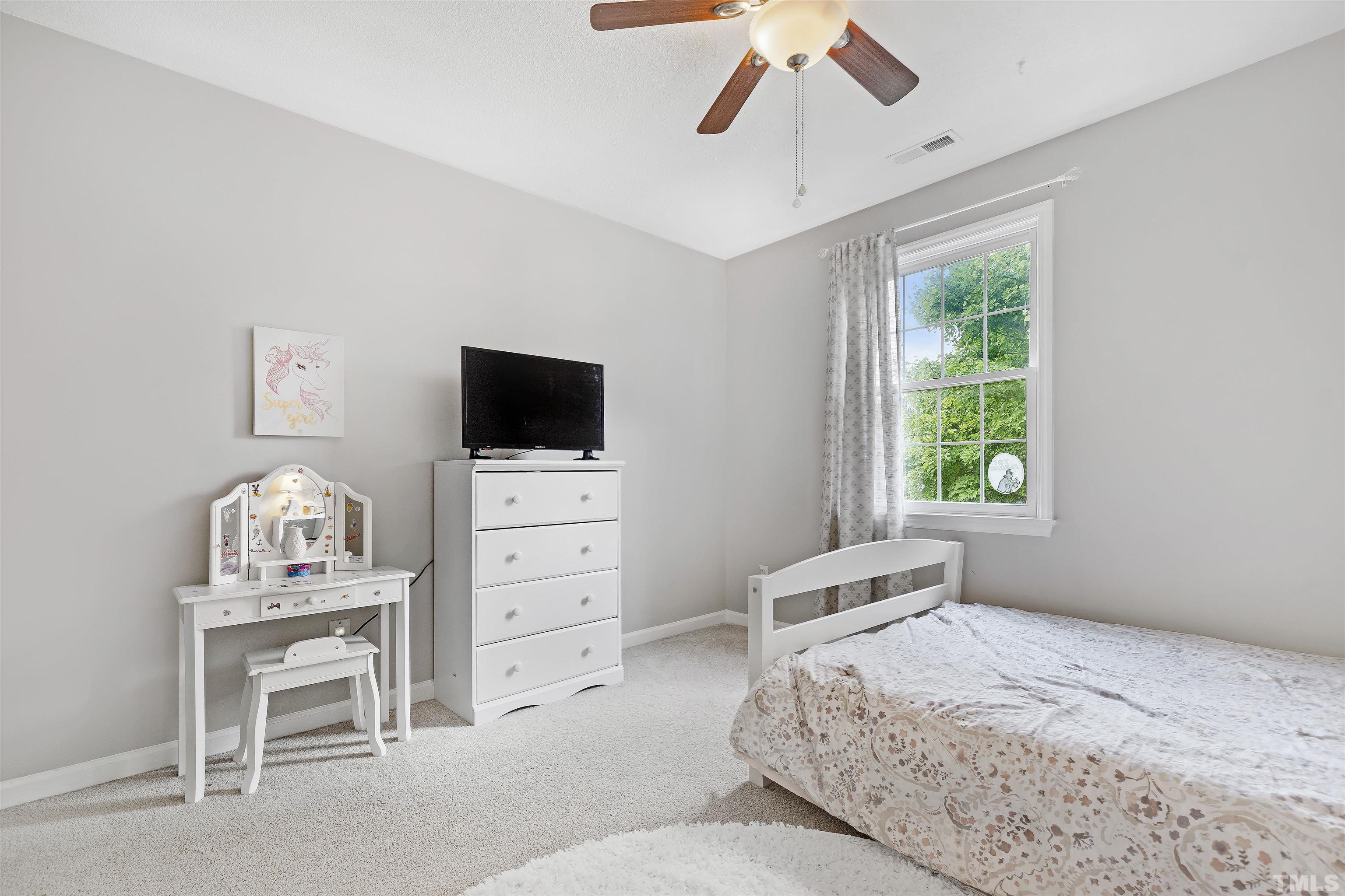 2309 Declaration Drive Raleigh, NC 27615 - Photo 21 of 30 a bedroom with a bed and a flat screen tv