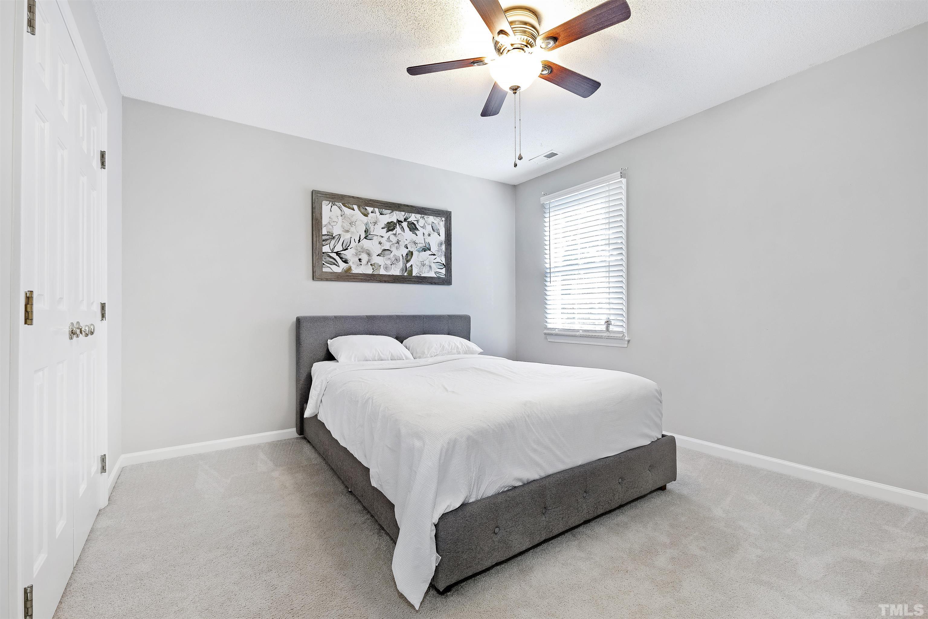 2309 Declaration Drive Raleigh, NC 27615 - Photo 23 of 30 a large bed sitting in a bedroom next to a window