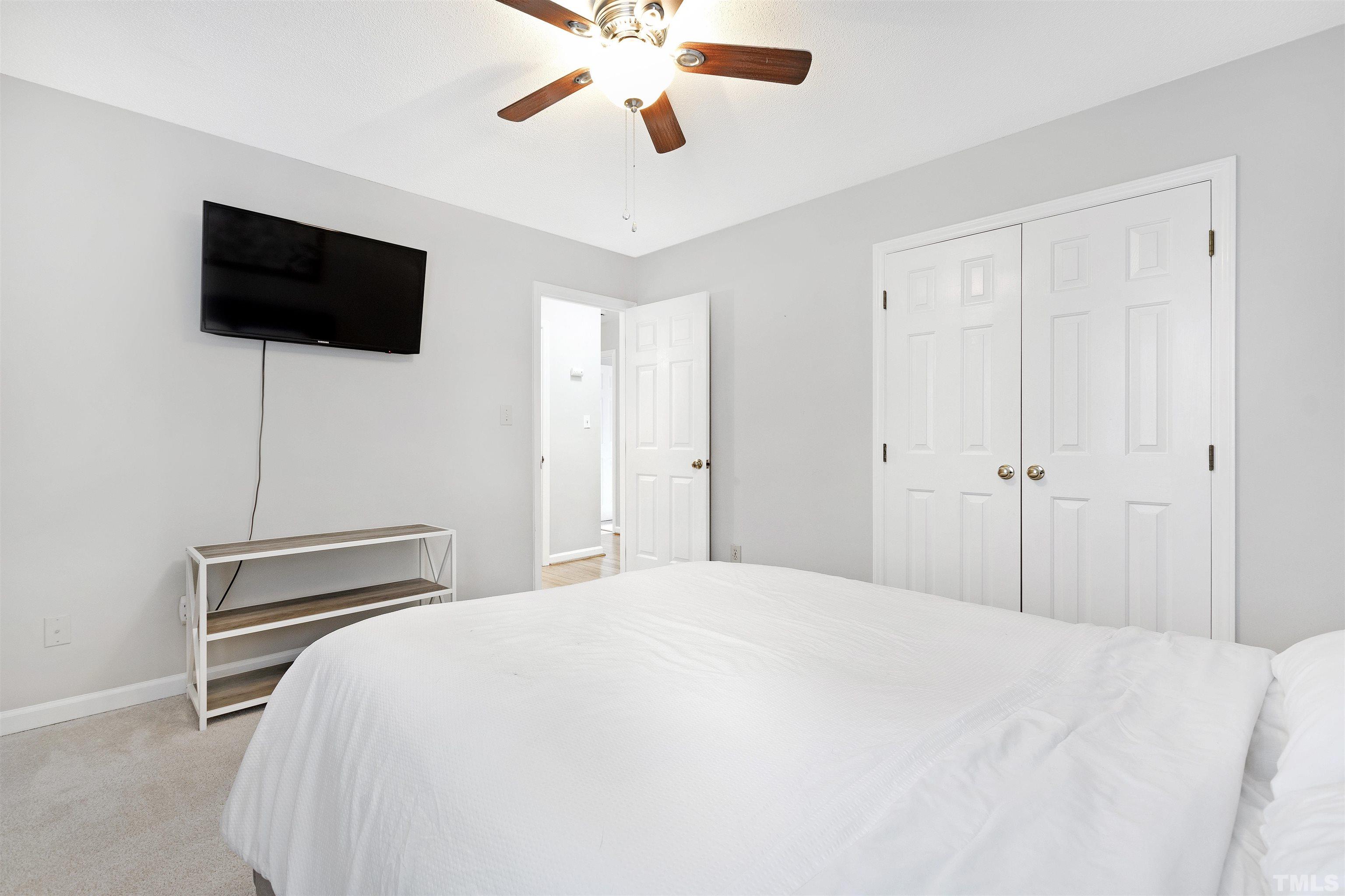 2309 Declaration Drive Raleigh, NC 27615 - Photo 24 of 30 a bedroom with a bed and a flat screen tv
