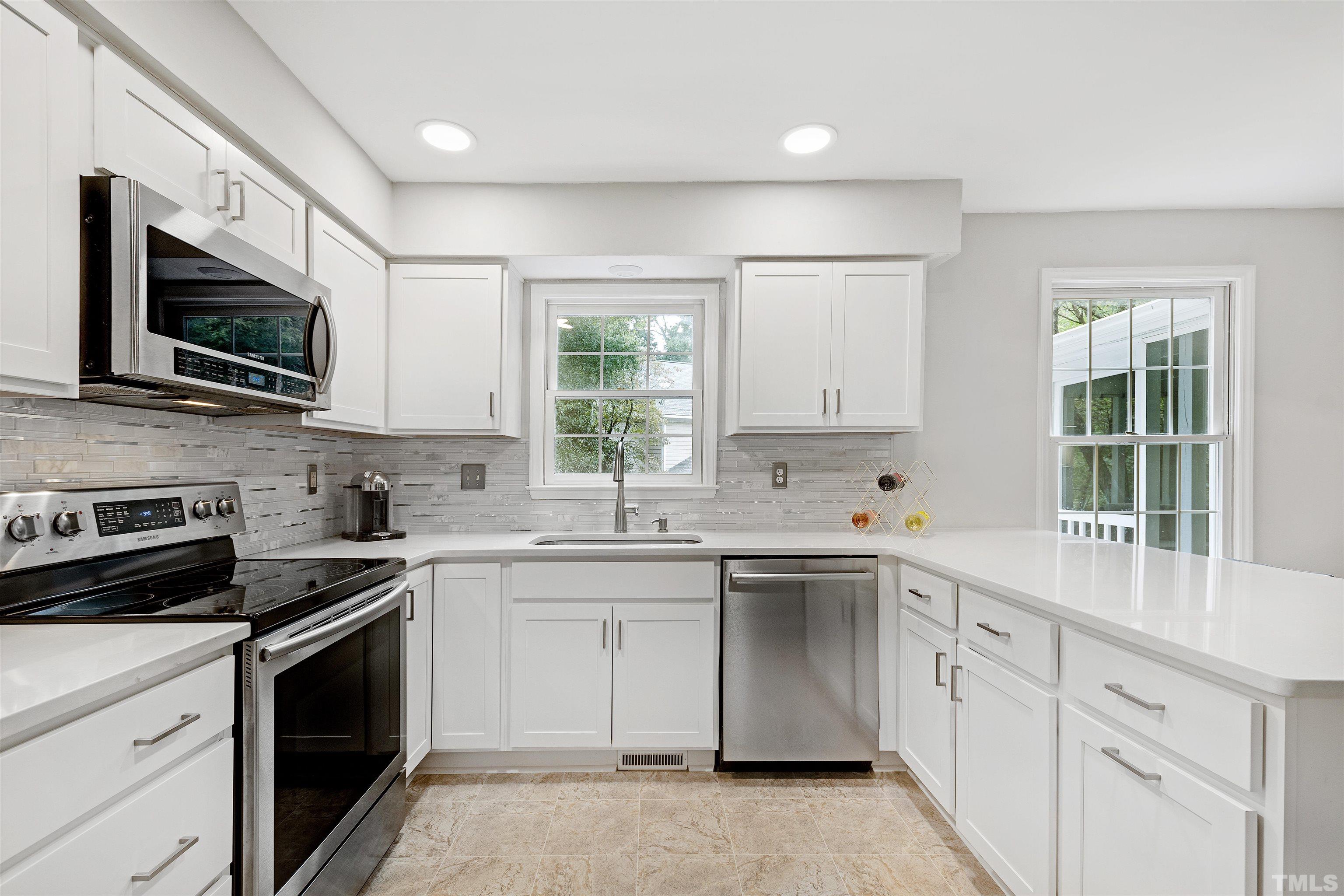 2309 Declaration Drive Raleigh, NC 27615 - Photo 4 of 30 a kitchen with a sink stove and microwave