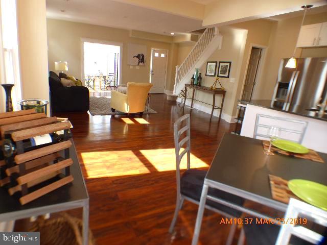 3102 Cedarhurst Road Baltimore, MD 21214 - Photo 15 of 42 a living room with chairs and kitchen view