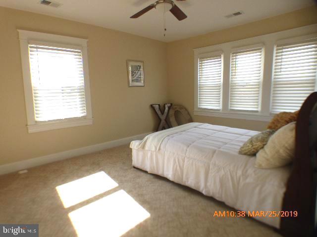 3102 Cedarhurst Road Baltimore, MD 21214 - Photo 31 of 42 a large bed sitting in a bedroom next to a window