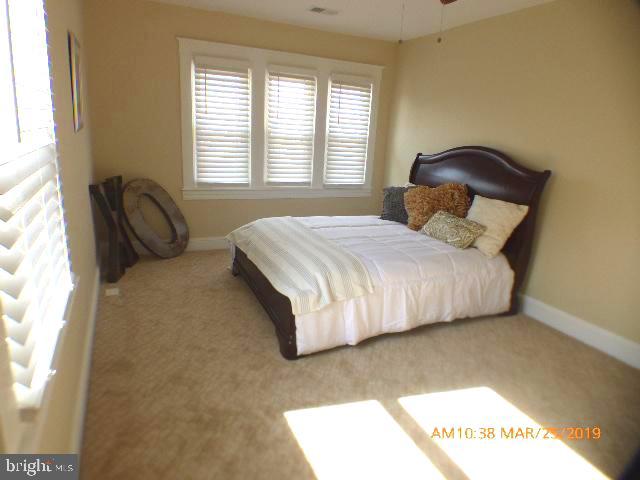 3102 Cedarhurst Road Baltimore, MD 21214 - Photo 32 of 42 a bedroom with a bed and a window