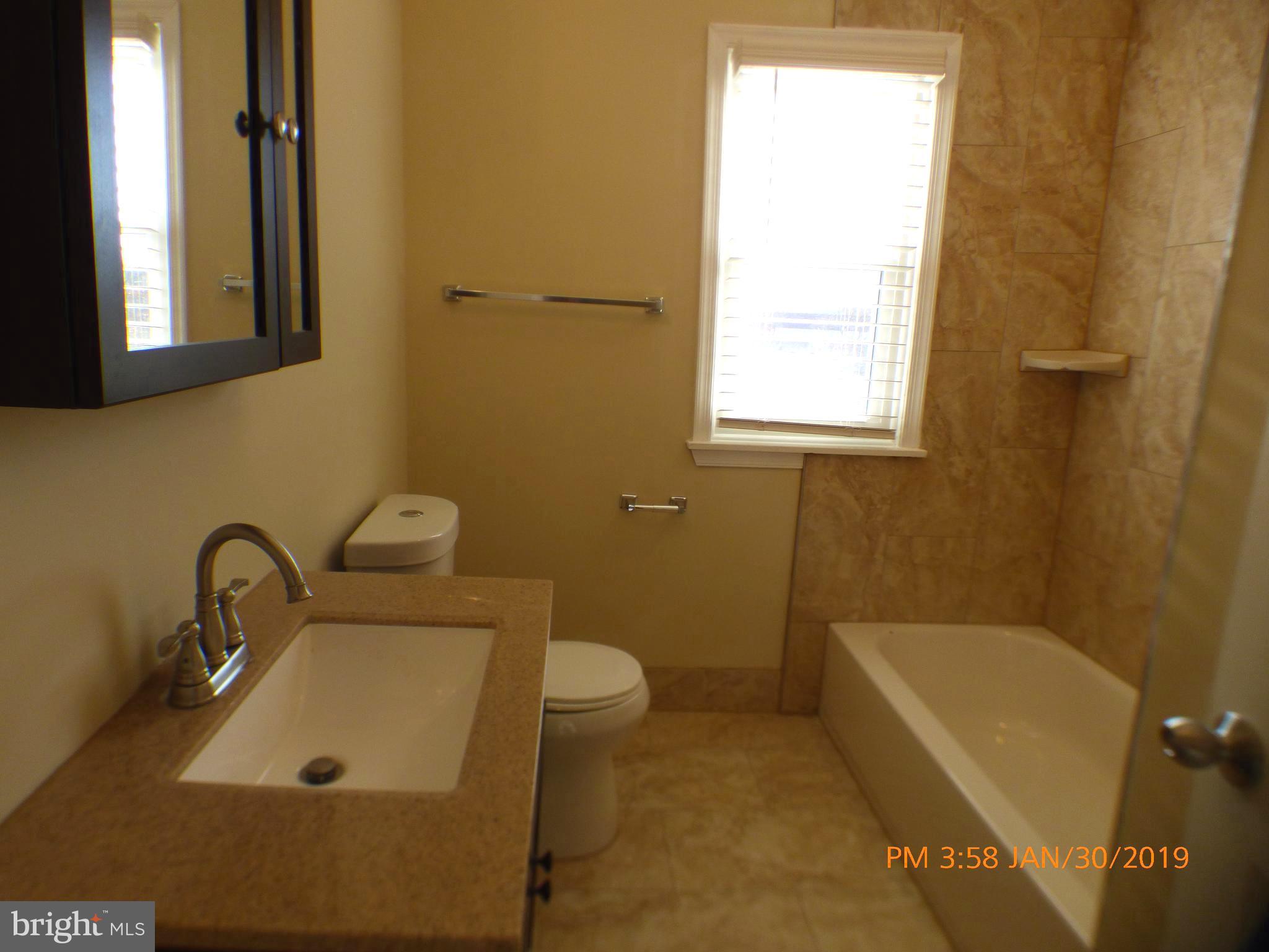3102 Cedarhurst Road Baltimore, MD 21214 - Photo 34 of 42 a bathroom with a sink and a bathtub