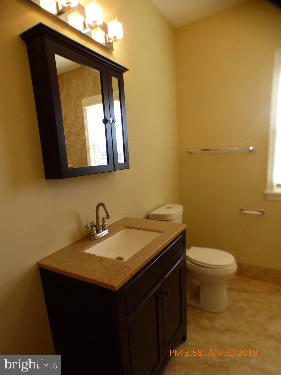 3102 Cedarhurst Road Baltimore, MD 21214 - Photo 35 of 42 a bathroom with a sink and a toilet