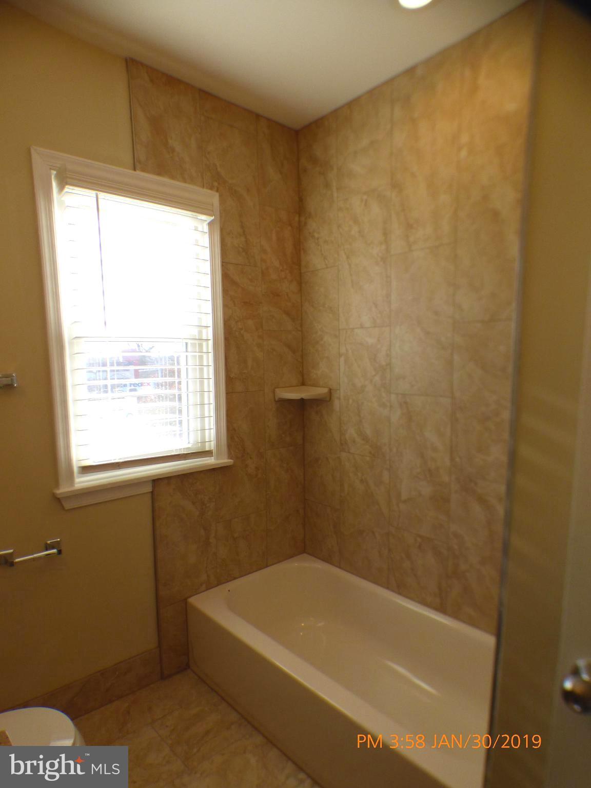 3102 Cedarhurst Road Baltimore, MD 21214 - Photo 36 of 42 a bathroom with a bathtub