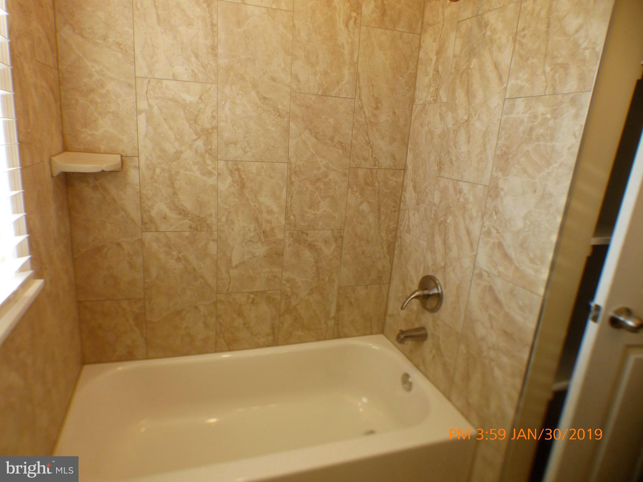 3102 Cedarhurst Road Baltimore, MD 21214 - Photo 37 of 42 a bathroom with a bathtub