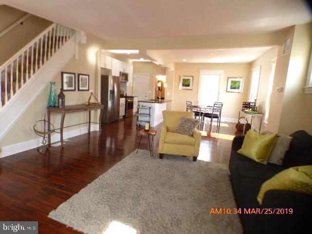 3102 Cedarhurst Road Baltimore, MD 21214 - Photo 5 of 42 a living room with furniture and wooden floor