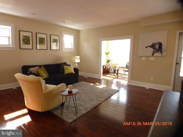 3102 Cedarhurst Road Baltimore, MD 21214 - Photo 7 of 42 a living room with furniture and a wooden floor