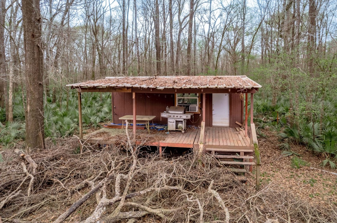 Lot 1-and Harper Branch Road Trinity, TX 75862 - Photo 6 of 21 a view of a patio with table and chairs under an umbrella