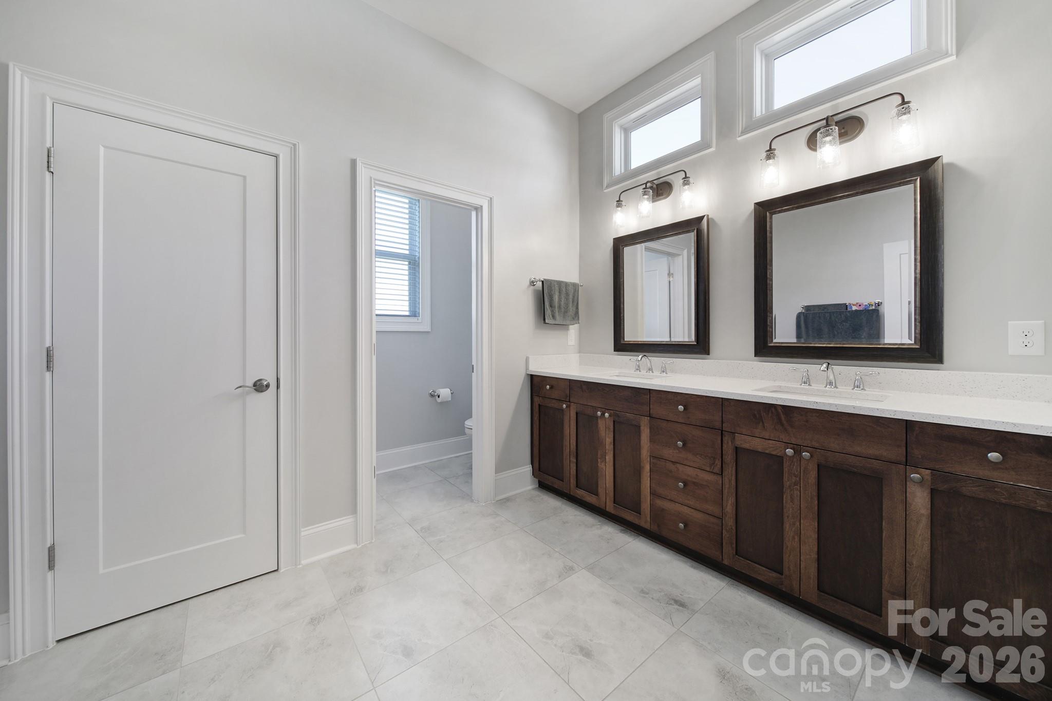 1633 Half Pint Loop Fort Mill, SC 29708 - Photo 19 of 48 a spacious bathroom with a double vanity sink and a mirror