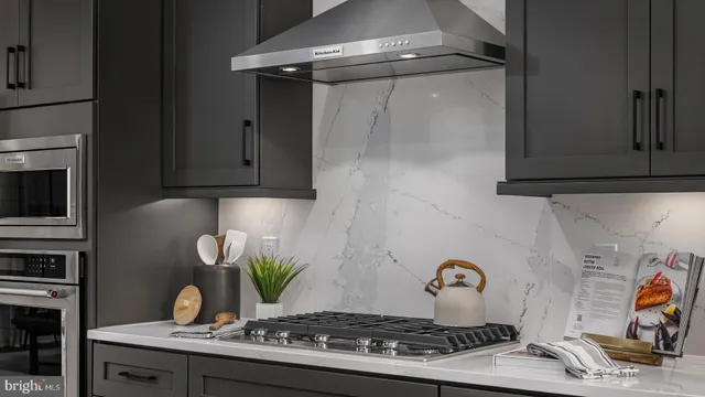 a stove top oven sitting inside of a kitchen