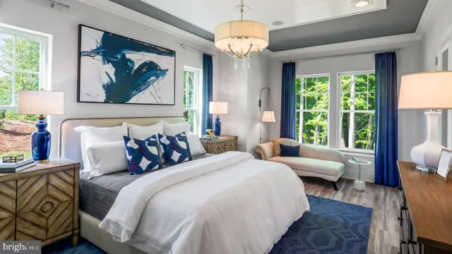 a bedroom with bed and a chandelier