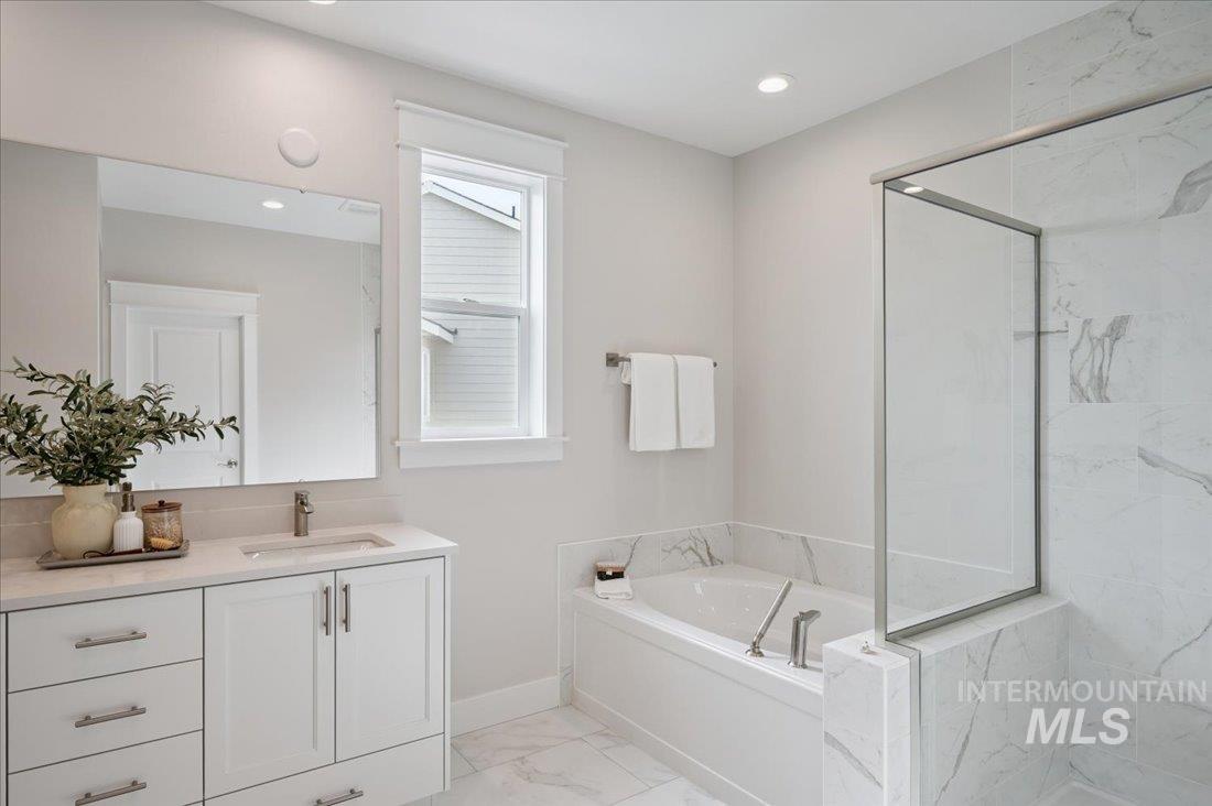 6271 West Snow Currant Street Meridian, ID 83646 - Photo 11 of 14 Full bath with vanity, a bath, light marble finish flooring, a marble finish shower, and recessed lighting