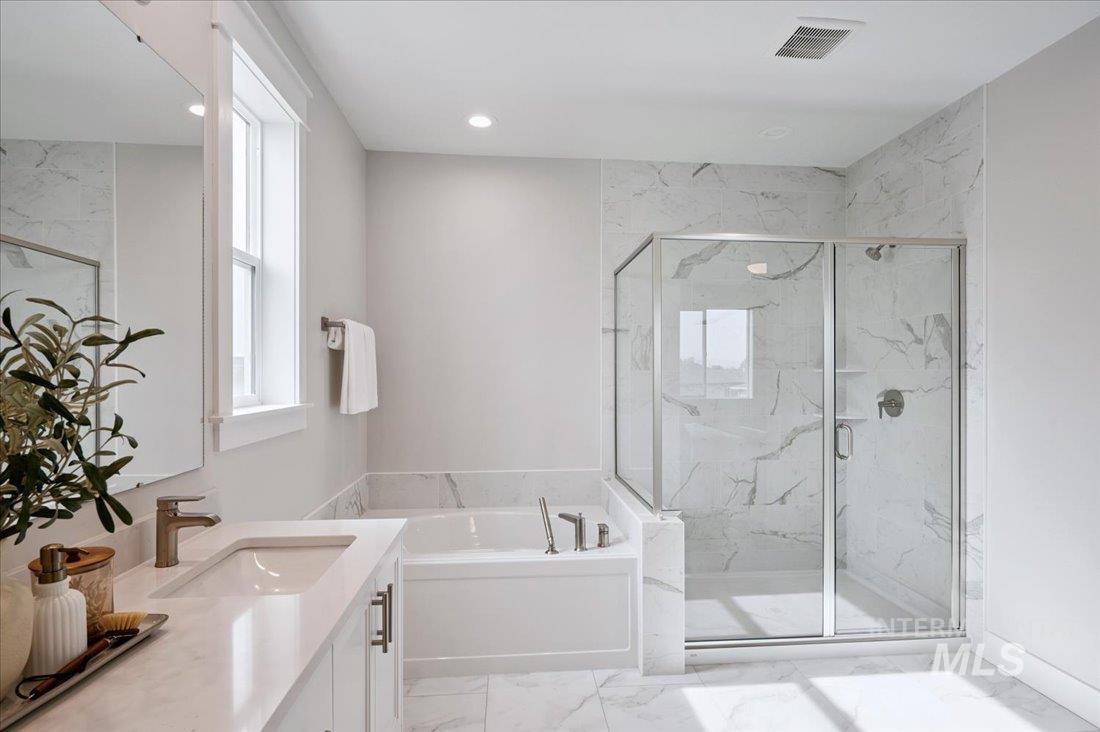 6271 West Snow Currant Street Meridian, ID 83646 - Photo 12 of 14 Bathroom with vanity, a bath, a marble finish shower, and light marble finish floors