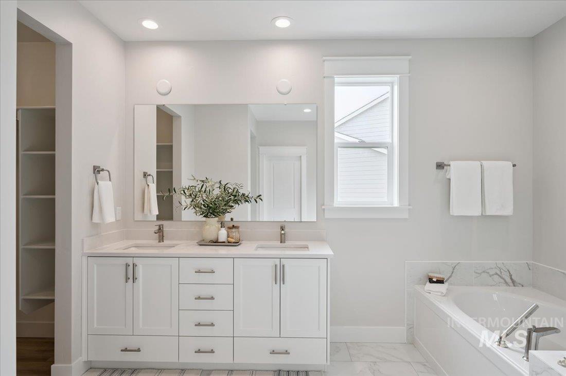 6271 West Snow Currant Street Meridian, ID 83646 - Photo 13 of 14 Full bath featuring double vanity, a garden tub, light marble finish floors, a walk in closet, and recessed lighting