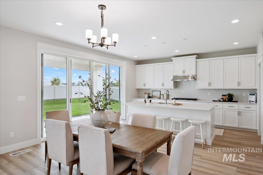 6271 West Snow Currant Street Meridian, ID 83646 - Photo 4 of 14 Dining area featuring light wood-type flooring and recessed lighting