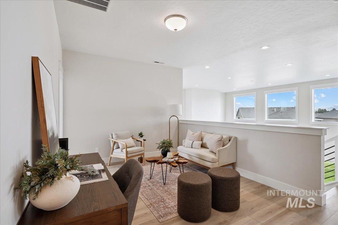 6271 West Snow Currant Street Meridian, ID 83646 - Photo 8 of 14 Loft with wood finished floors, recessed lighting, an upstairs landing, and a textured ceiling