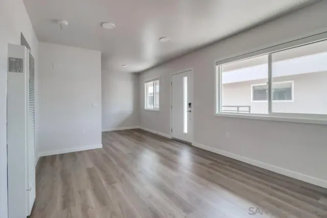 a view of a kitchen with a sink a refrigerator and window