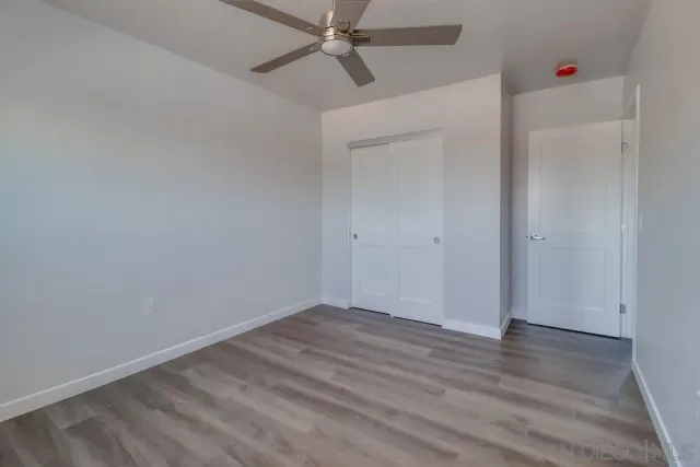 a view of a building with car parked on the road