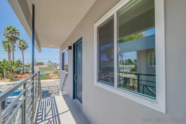 a view of a balcony with chair and wooden floor