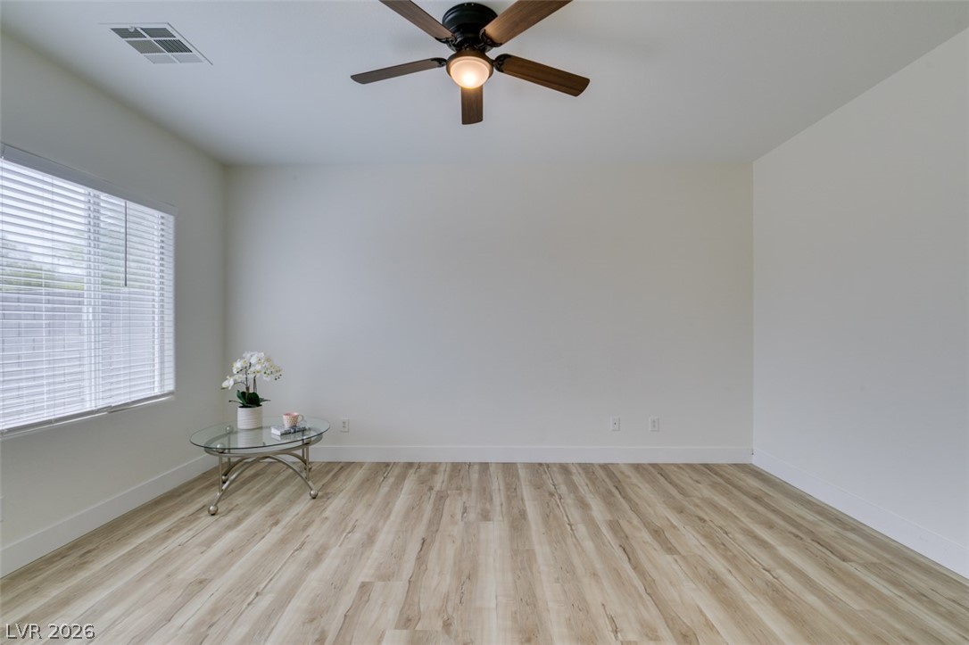 10959 Pumpkin Ridge Avenue Las Vegas, NV 89135 - Photo 24 of 51 An optimal living space offers a neutral palette with light wood-look flooring and a ceiling fan for comfort.