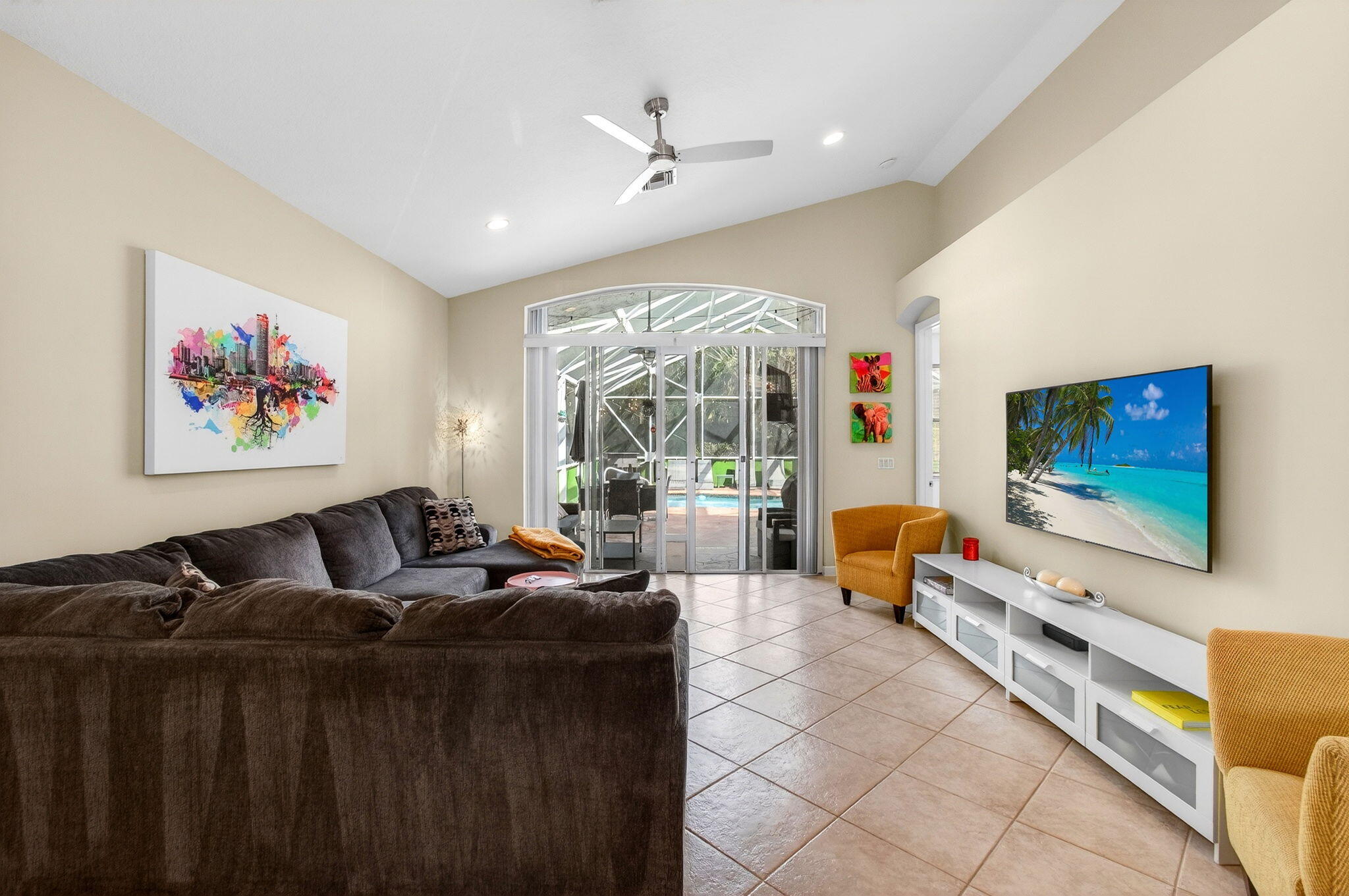 6737 Southport Drive Boynton Beach, FL 33472 - Photo 24 of 99 a living room with furniture a flat screen tv and a floor to ceiling window
