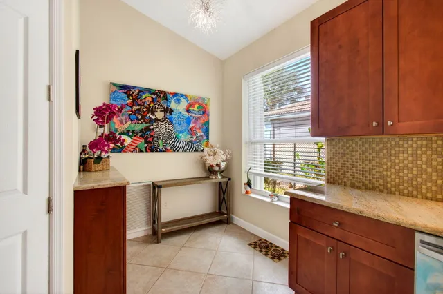 a view of a patio with couches and a table and chairs with wooden floor