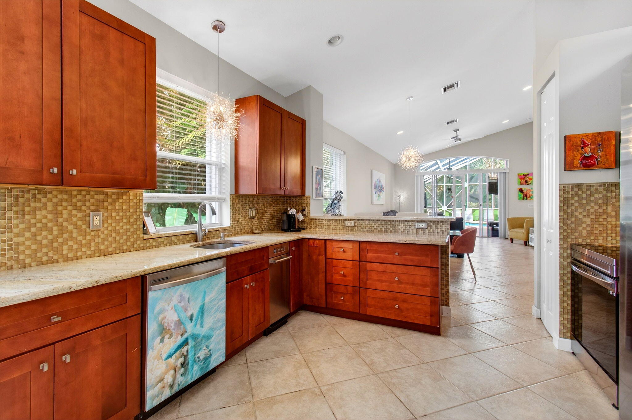 6737 Southport Drive Boynton Beach, FL 33472 - Photo 35 of 99 a kitchen with stainless steel appliances granite countertop wooden cabinets a sink and dishwasher