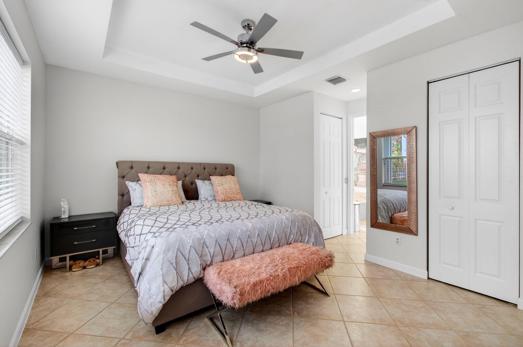 6737 Southport Drive Boynton Beach, FL 33472 - Photo 42 of 99 a bedroom with a bed and a ceiling fan