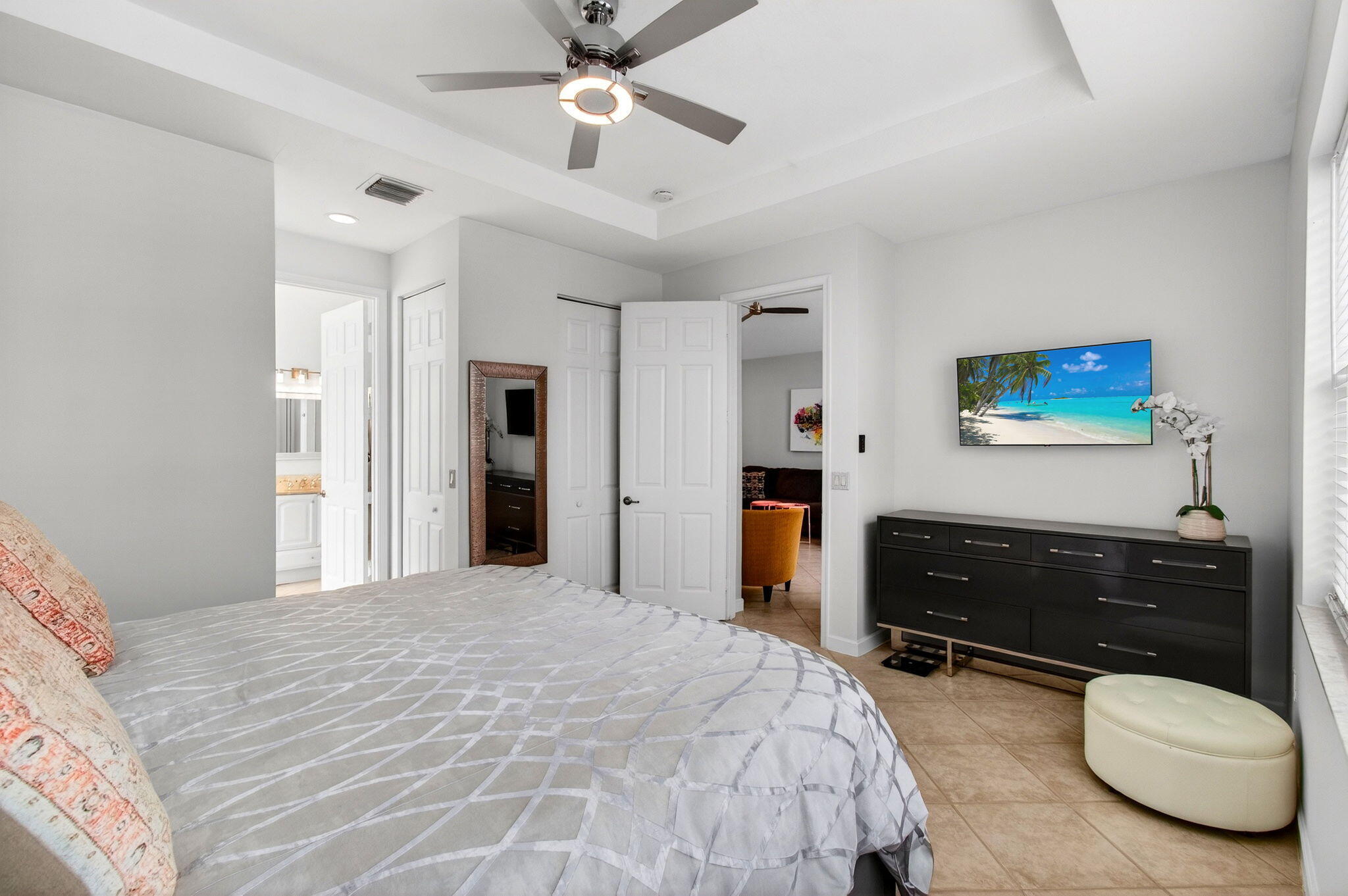 6737 Southport Drive Boynton Beach, FL 33472 - Photo 43 of 99 a bedroom with a bed and a chandelier