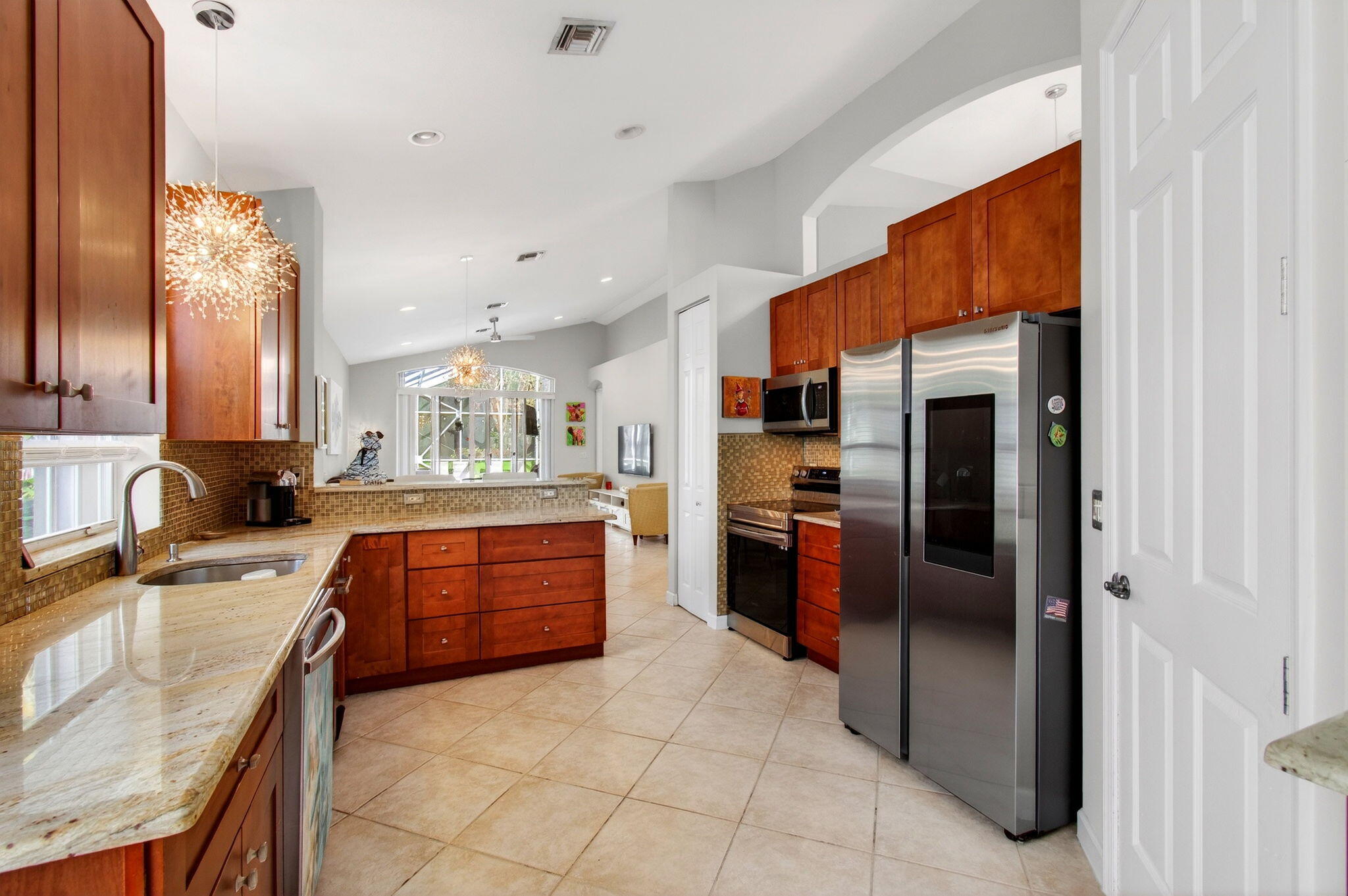 6737 Southport Drive Boynton Beach, FL 33472 - Photo 8 of 99 a large kitchen with a large counter top stainless steel appliances and cabinets
