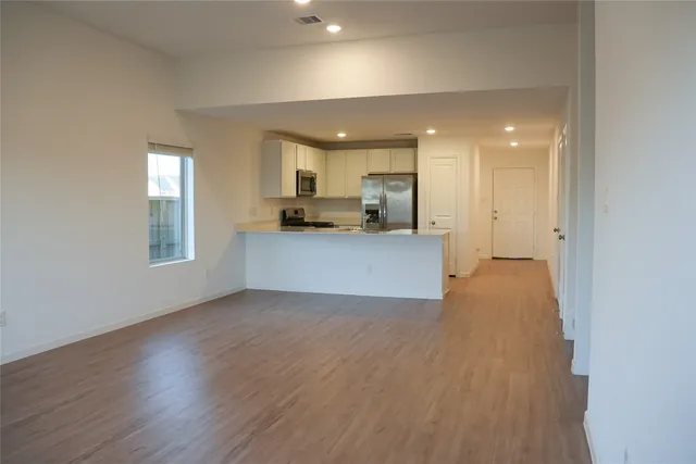 a view of a kitchen with a sink and a refrigerator