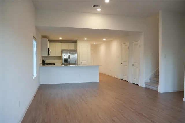 a view of kitchen with wooden floor and electronic appliances