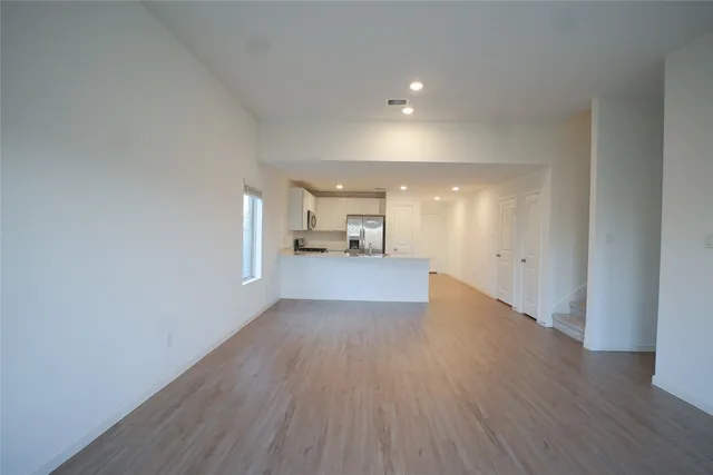 a view of a kitchen with wooden floor