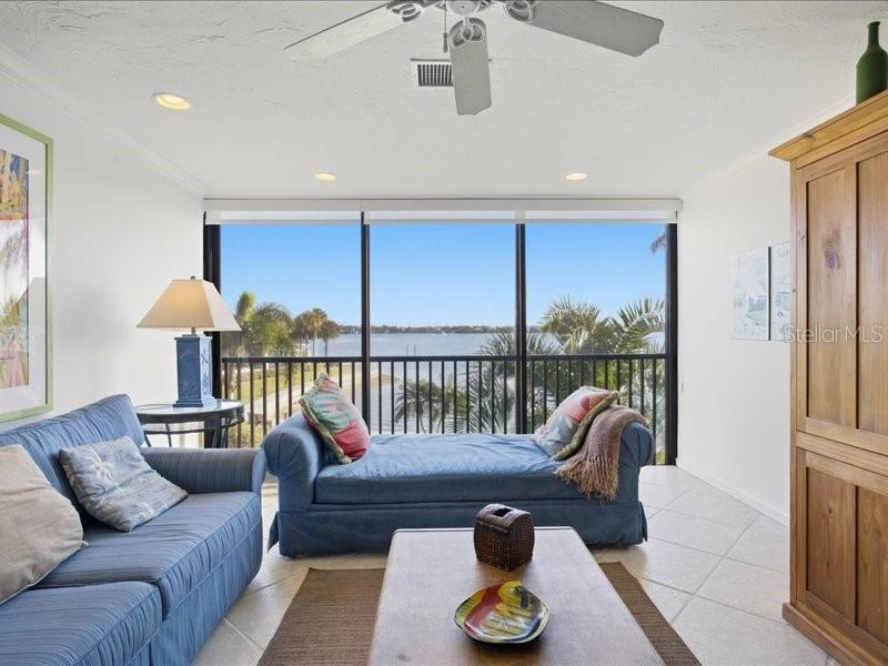 8911 Midnight Pass Road, Unit 208 Sarasota, FL 34242 - Photo 13 of 46 a living room with furniture and a table