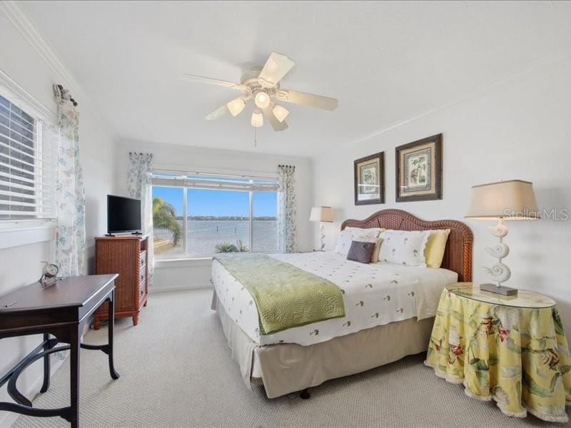 8911 Midnight Pass Road, Unit 208 Sarasota, FL 34242 - Photo 15 of 46 a bedroom with a bed and a table in it