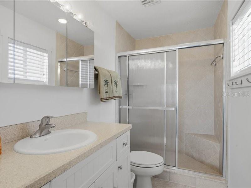 8911 Midnight Pass Road, Unit 208 Sarasota, FL 34242 - Photo 16 of 46 a bathroom with a sink toilet and shower