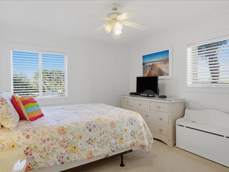 8911 Midnight Pass Road, Unit 208 Sarasota, FL 34242 - Photo 17 of 46 a bedroom with a bed and a television