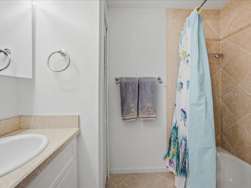 8911 Midnight Pass Road, Unit 208 Sarasota, FL 34242 - Photo 18 of 46 a bathroom with a granite countertop sink and a mirror