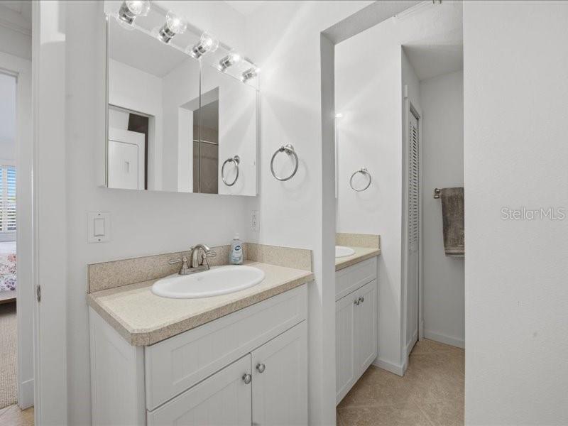 8911 Midnight Pass Road, Unit 208 Sarasota, FL 34242 - Photo 19 of 46 a bathroom with a sink vanity and a mirror