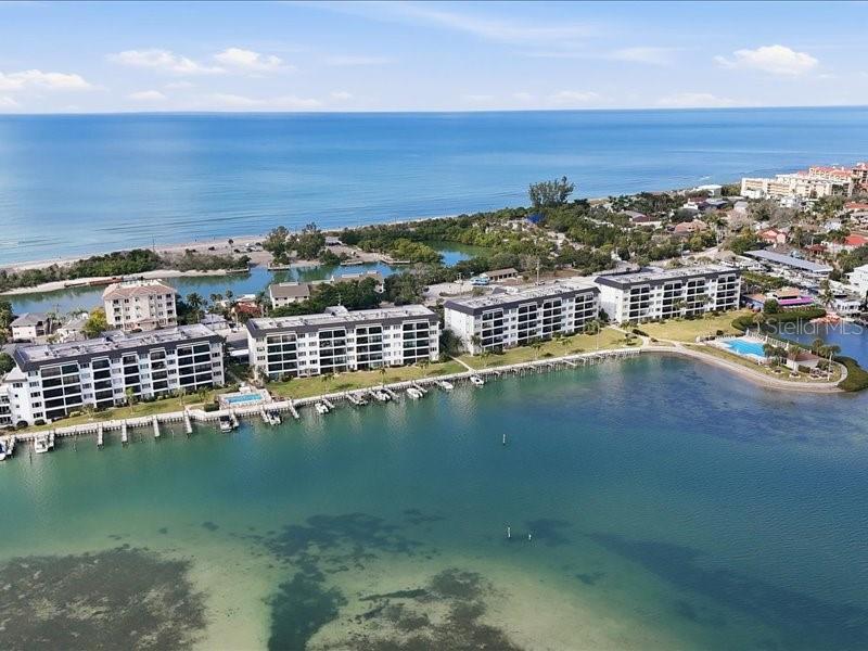 8911 Midnight Pass Road, Unit 208 Sarasota, FL 34242 - Photo 28 of 46 an aerial view of a houses with a lake view