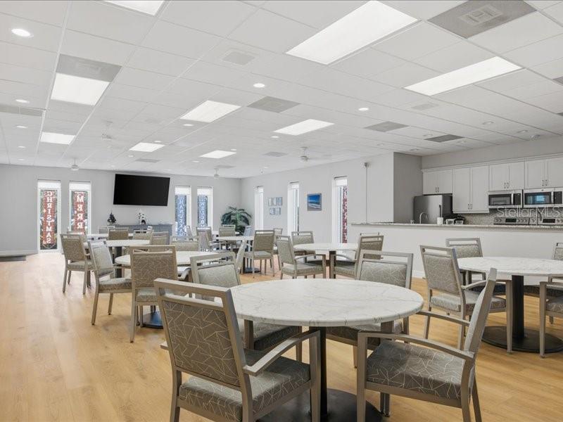 8911 Midnight Pass Road, Unit 208 Sarasota, FL 34242 - Photo 30 of 46 a view of a dining room with furniture and wooden floor